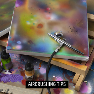 airbrusing tips - an airbrush pen resting on a painted canvas