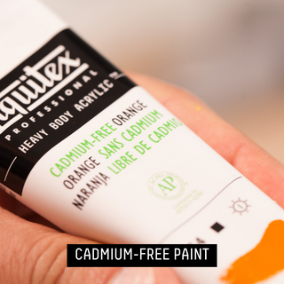 CREATING CADMIUM-FREE PAINT - bottle of heavy body cadmium-free orange in artists hand