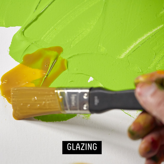 Glazing - artist using paintbrush to add glazing medium to artwork