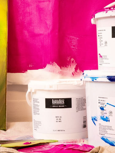 Liquitex large sizes paint next to a painted canvas